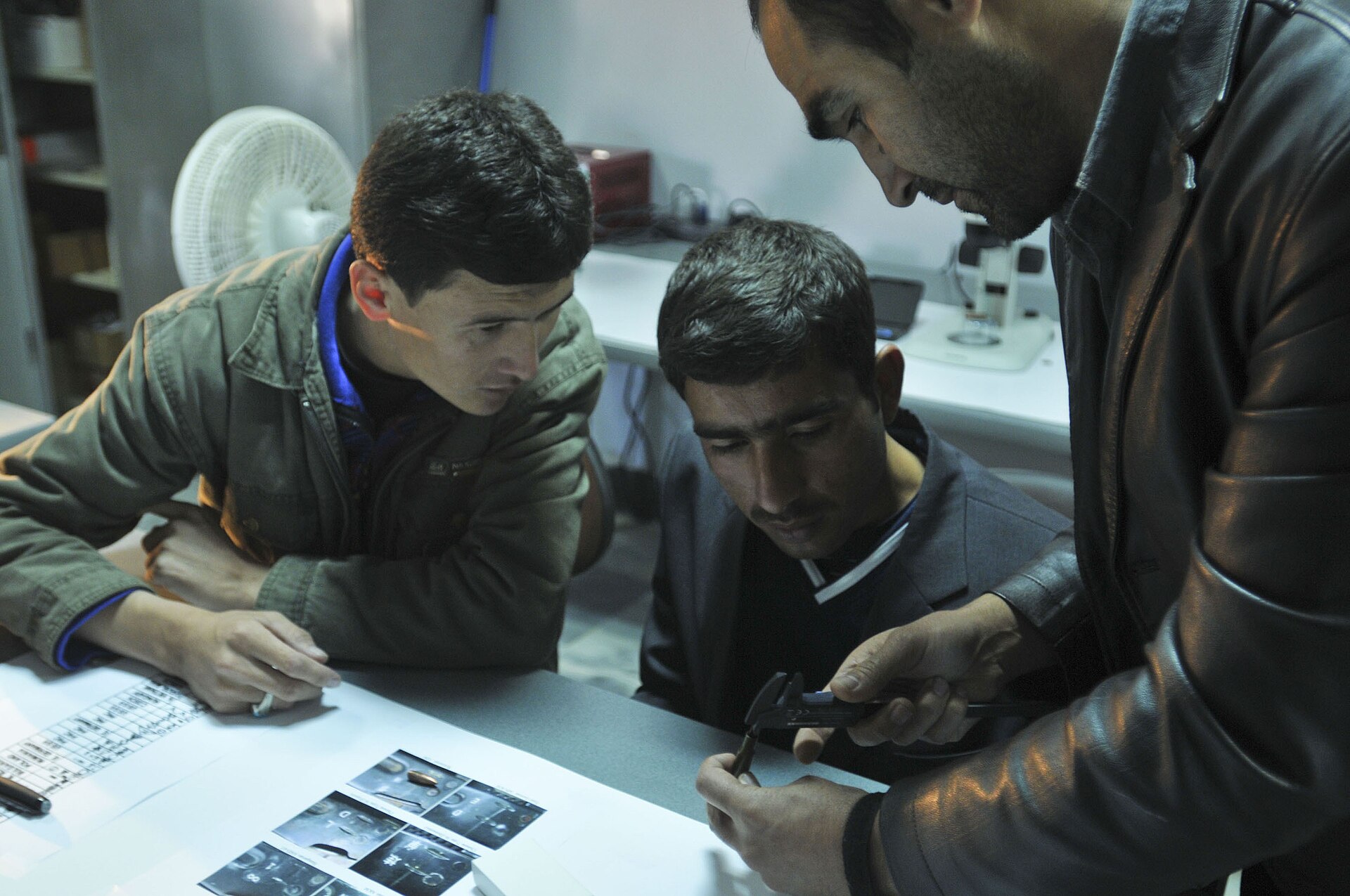 Police students receiving forensic training in a classroom and laboratory setting